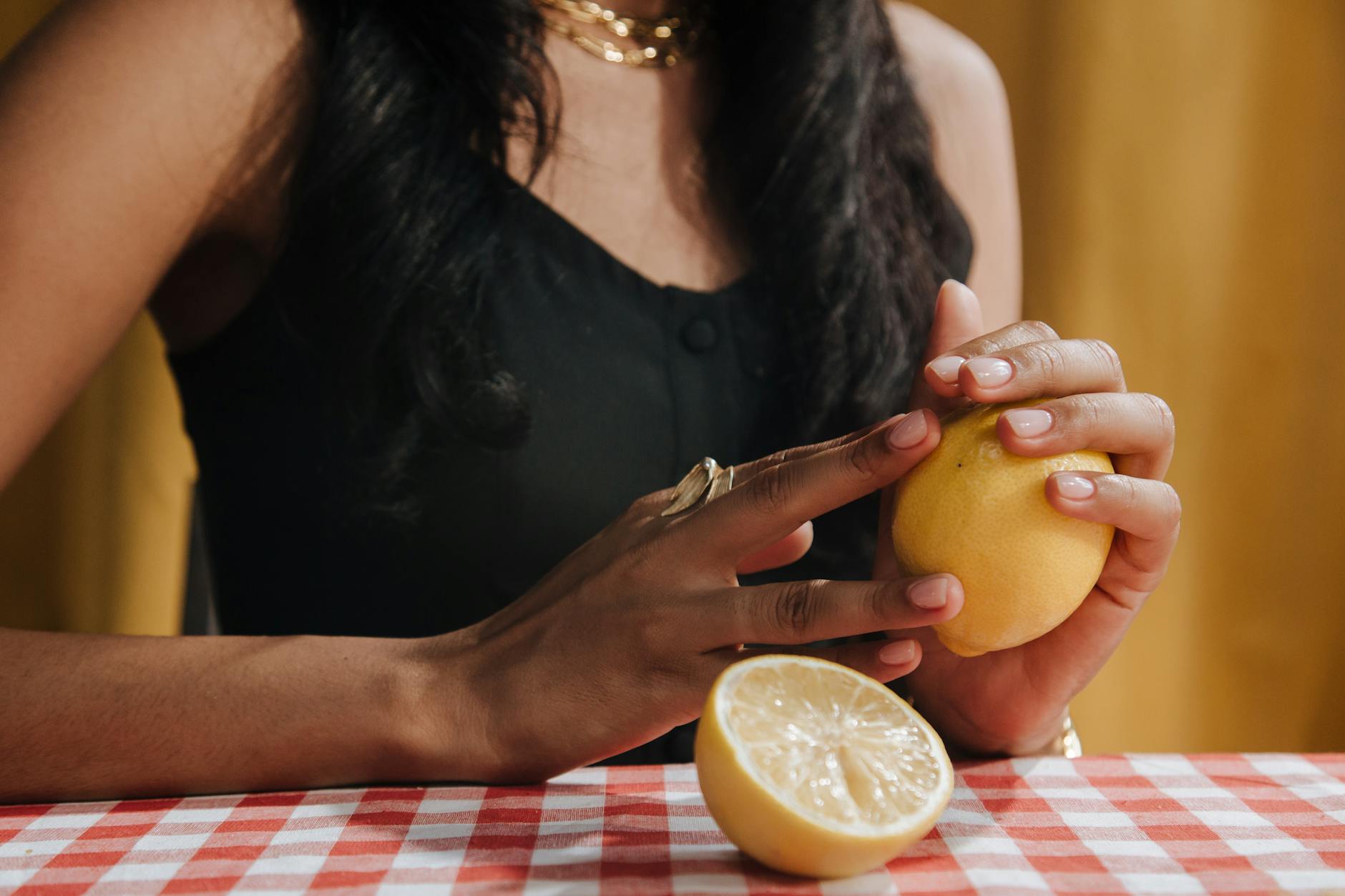 Bright yellow lemons arranged on a pastel green background, symbolizing fresh starts and renewed desire