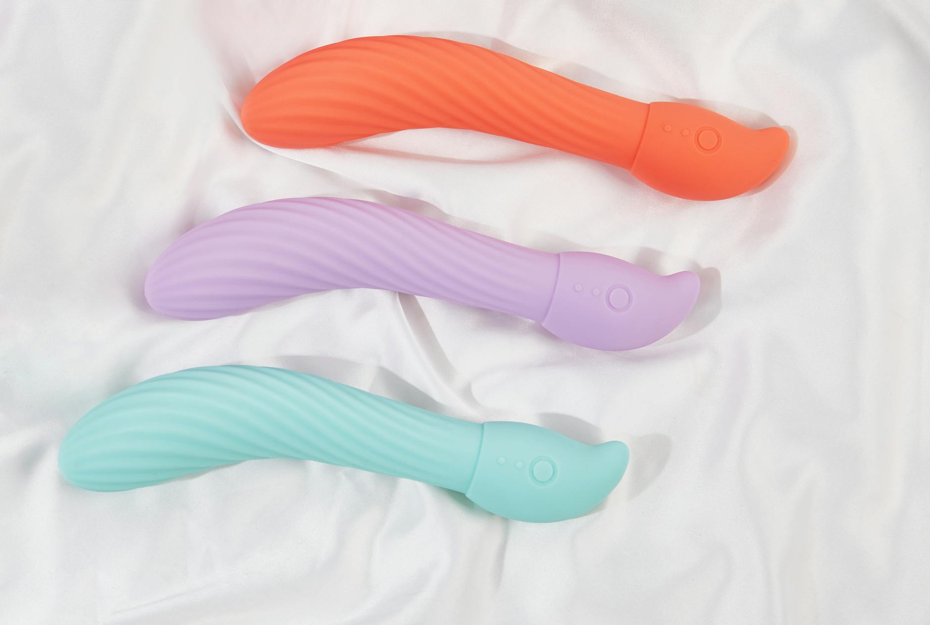 A teal lemon vibrator on soft white silk fabric, ready for quick sessions.