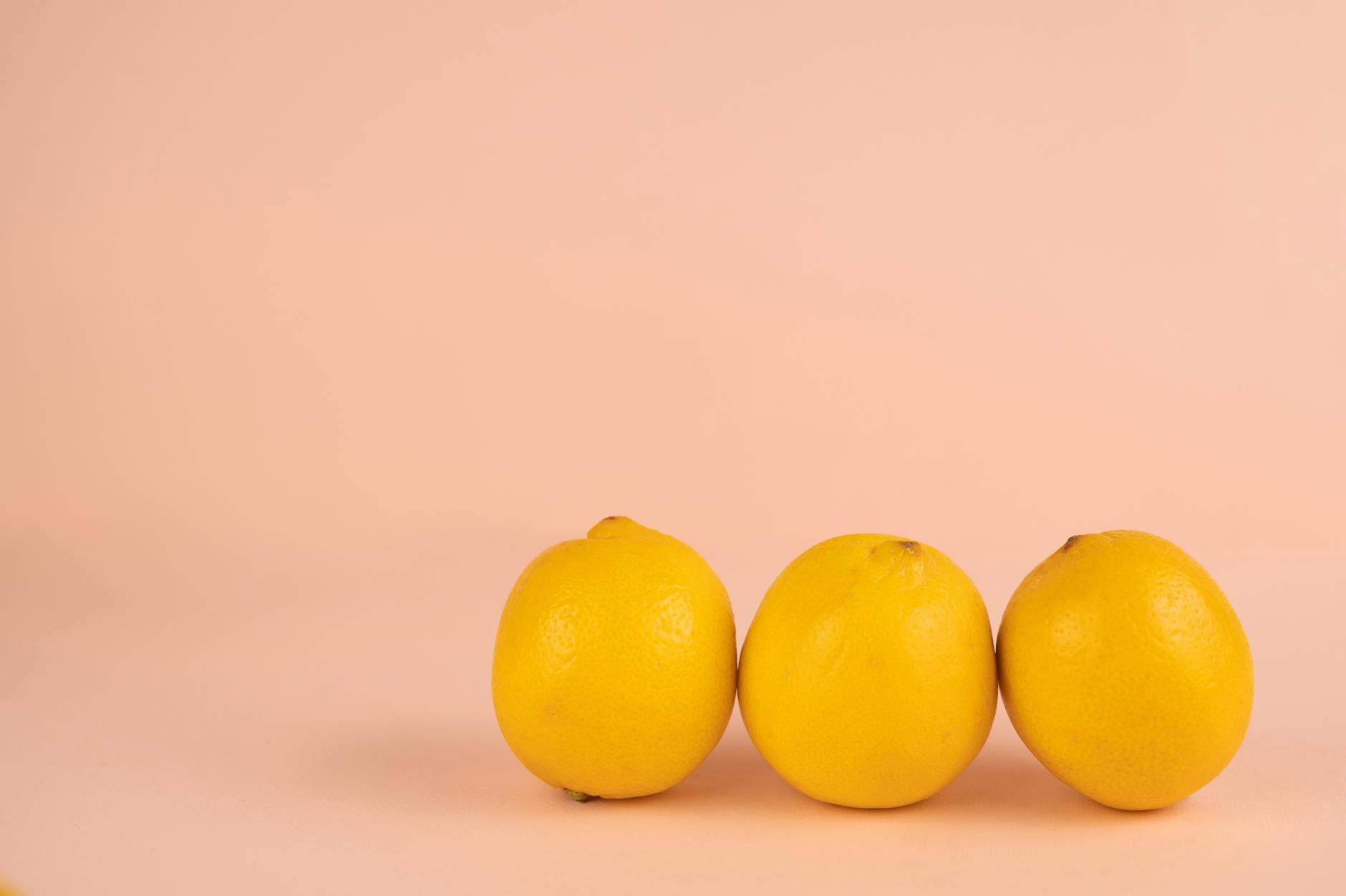 Bright ripe lemons arranged on a soft pastel background